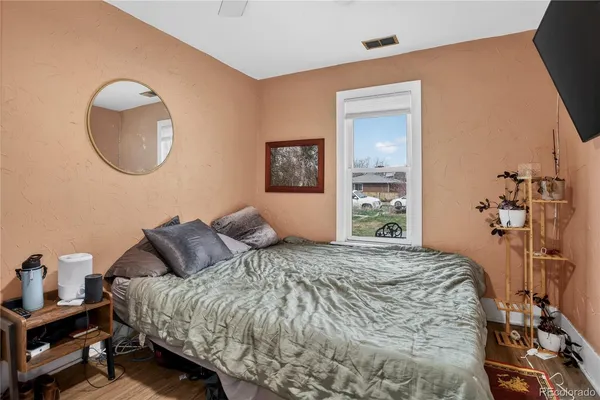 a bedroom with a bed and a mirror