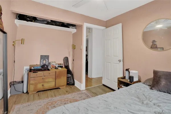 a bedroom with a bed and a mirror