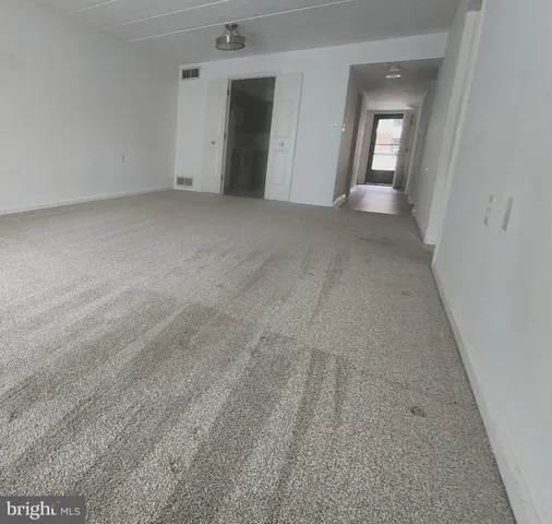 a kitchen with granite countertop a sink stove and refrigerator