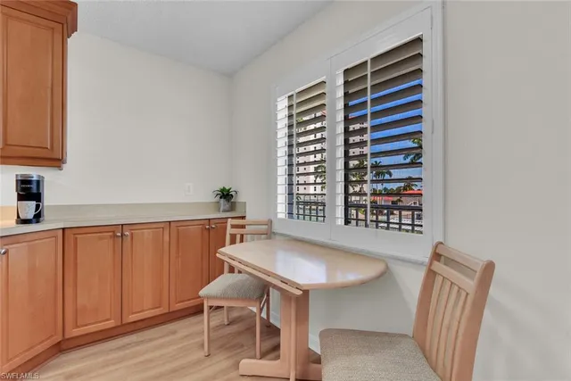 a view of a bedroom with a table and chairs