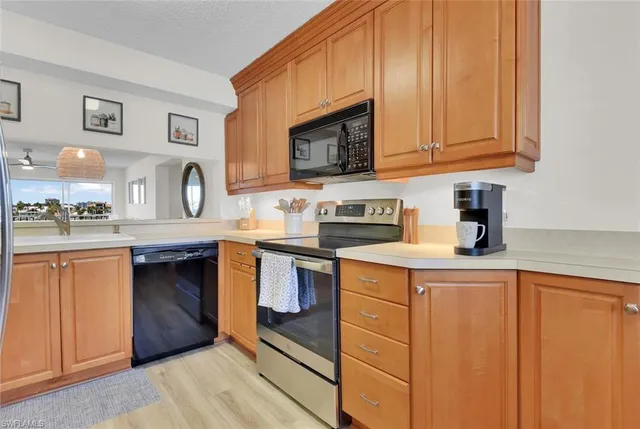 a kitchen with stainless steel appliances granite countertop a sink stove and microwave