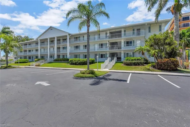 a view of pool with a table and chairs