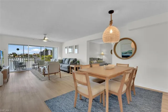 a dining room with furniture garden view and wooden floor