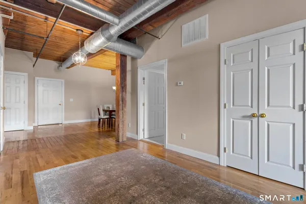 a view of a hallway with wooden floor