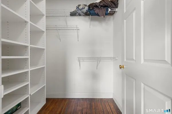 a view of walk in closet with empty racks