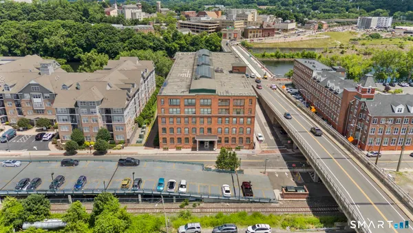 an aerial view of residential houses with outdoor space and swimming pool