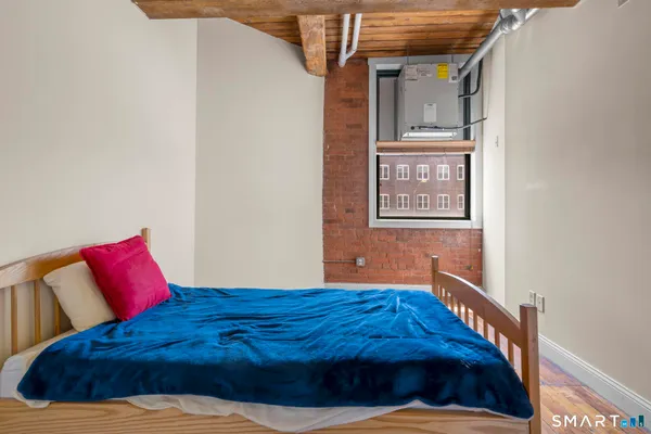 a bedroom with a bed and a night stand