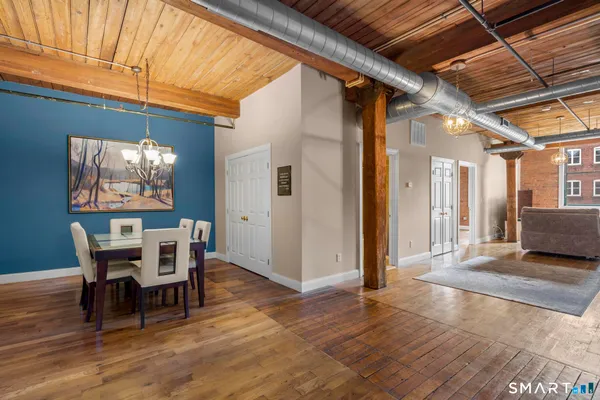 a view of a dining room with furniture and wooden floor