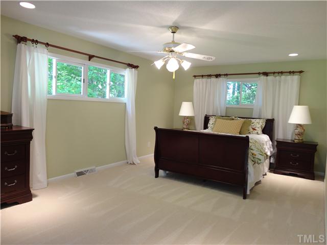 8804 Katharina Court Raleigh, NC 27613 - Photo 8 of 22 a living room with furniture a bed and a flat screen tv