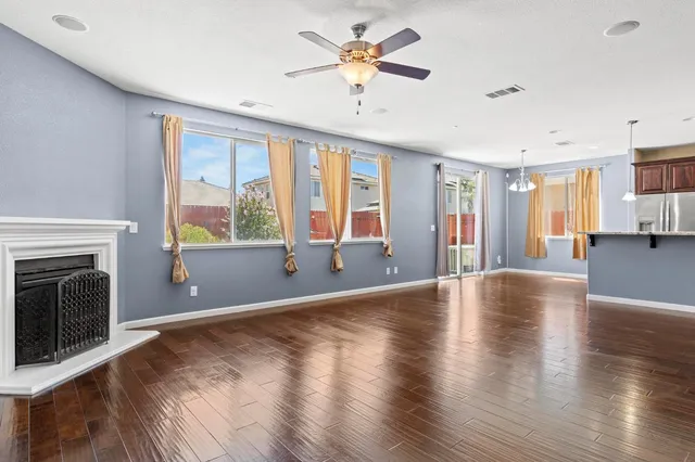 a view of an empty room with a fireplace and a window