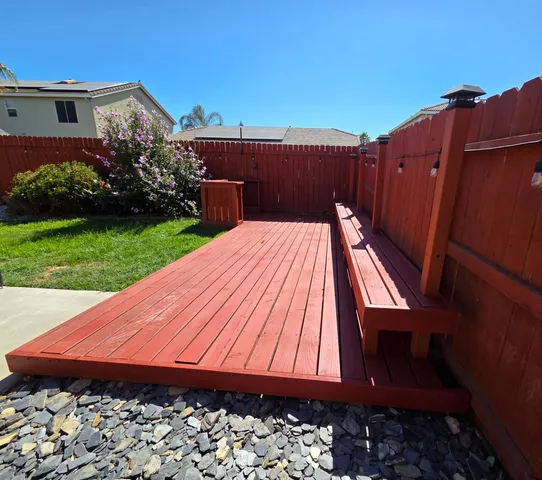 a view of a backyard with wooden fence