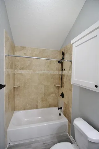 a bathroom with a toilet and bathtub