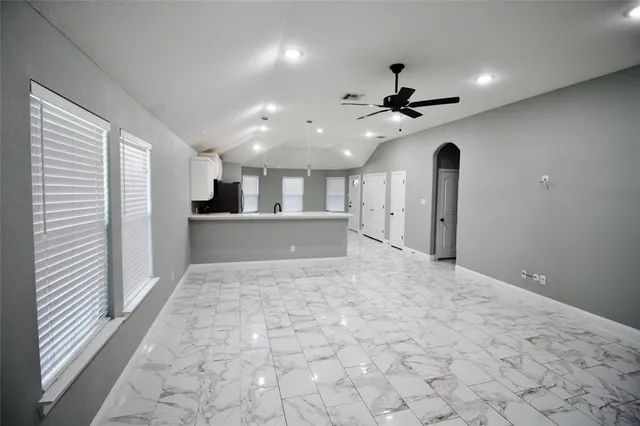 a view of a kitchen with a sink and a ceiling fan
