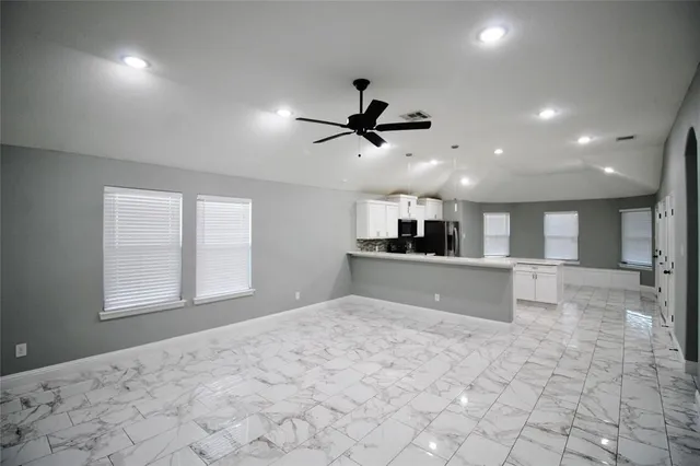 a view of a kitchen with a sink and a window