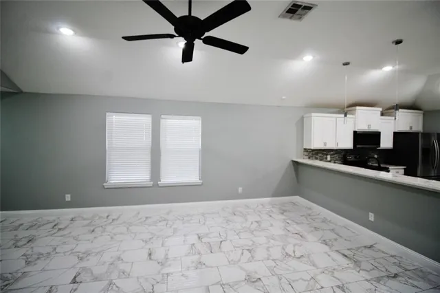 a view of a kitchen with a sink and cabinets