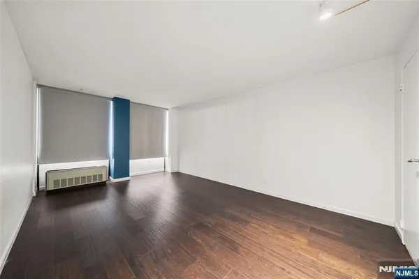 a view of an empty room and wooden floor