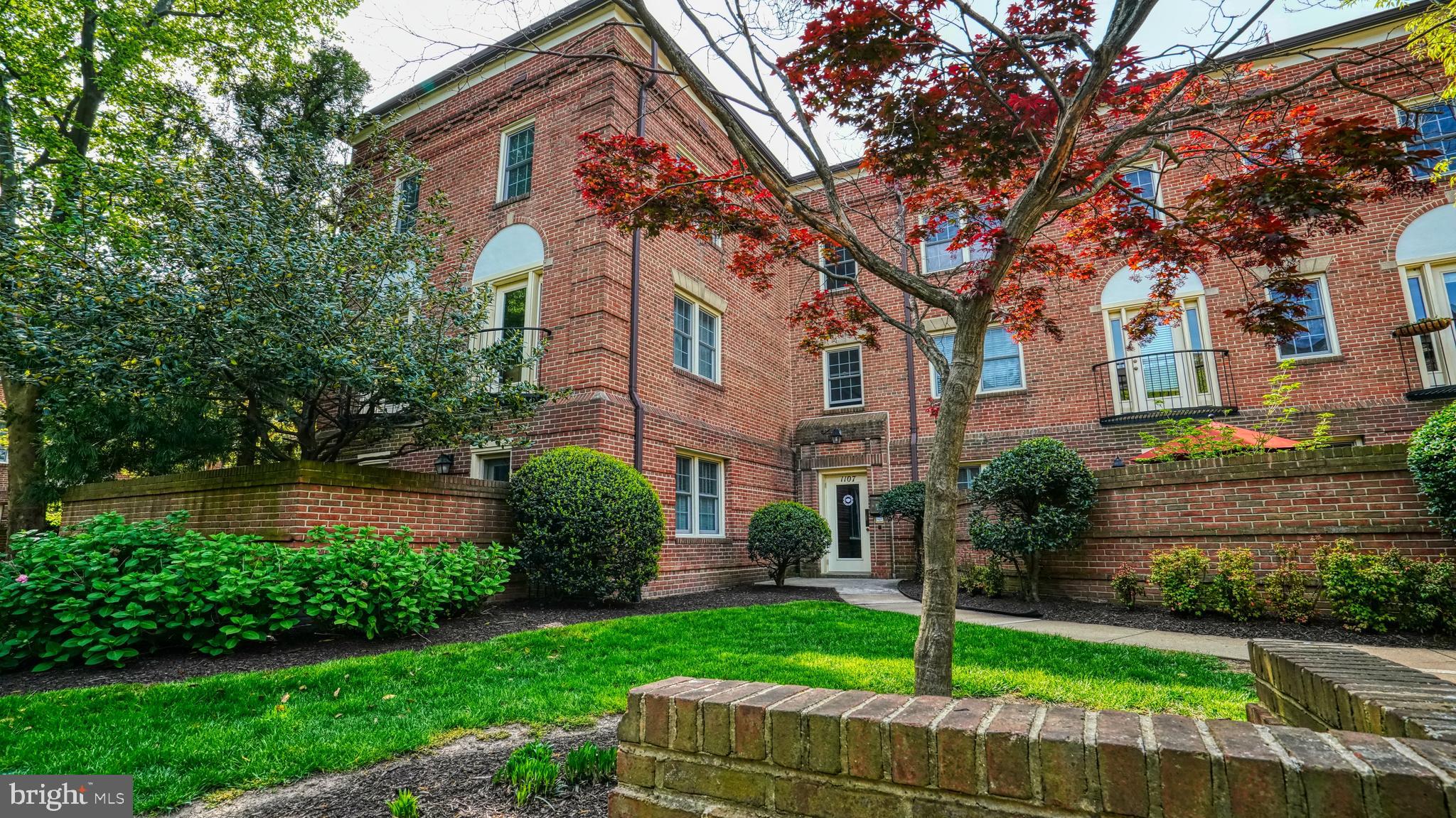 1107 North Pitt Street, Unit 2A Alexandria, VA 22314 - Photo 1 of 32 a front view of a house with a yard and garage