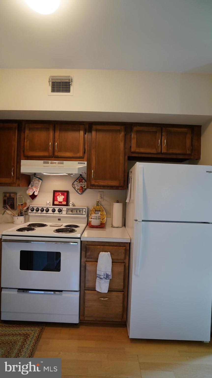 1107 North Pitt Street, Unit 2A Alexandria, VA 22314 - Photo 14 of 32 a utility room with stainless steel appliances granite countertop a sink and a stove