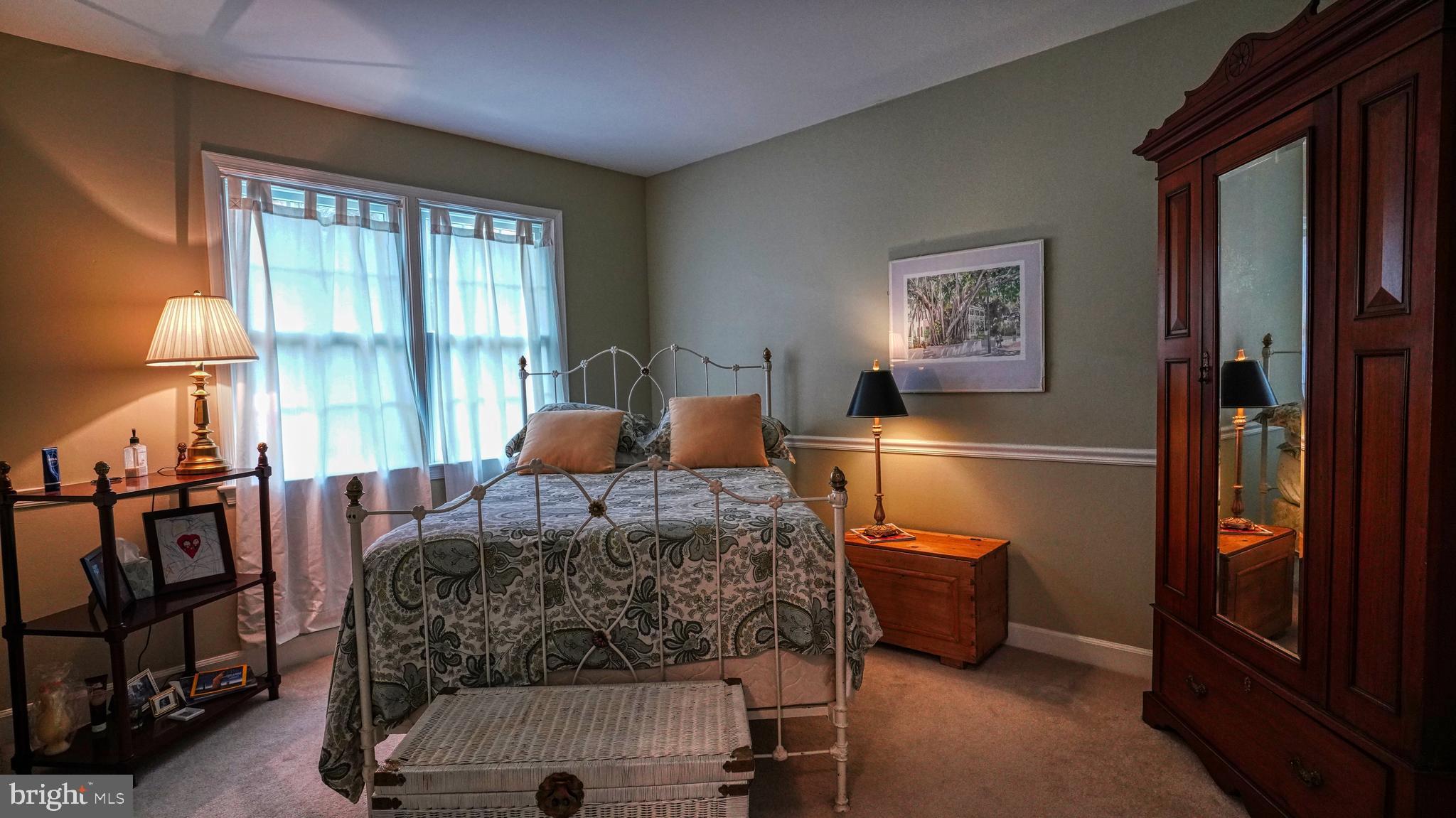 1107 North Pitt Street, Unit 2A Alexandria, VA 22314 - Photo 24 of 32 a bedroom with a bed and a dresser next to a window