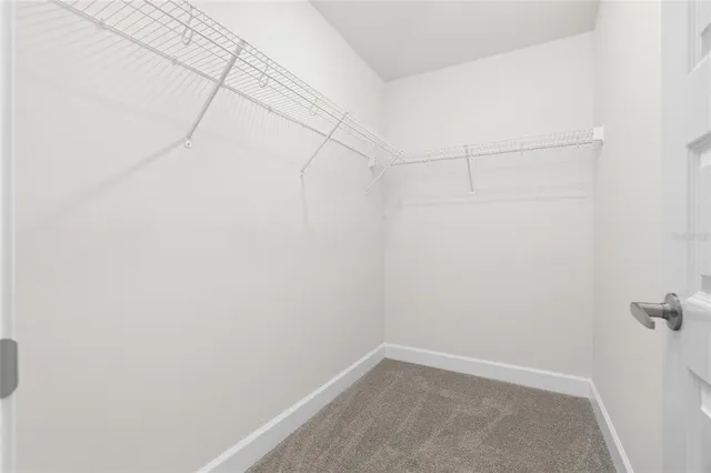 a bathroom with a granite countertop double vanity sink and a mirror