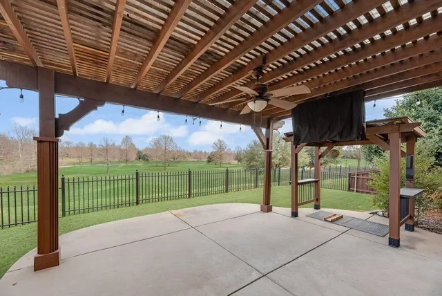 a view of a house with backyard and sitting area