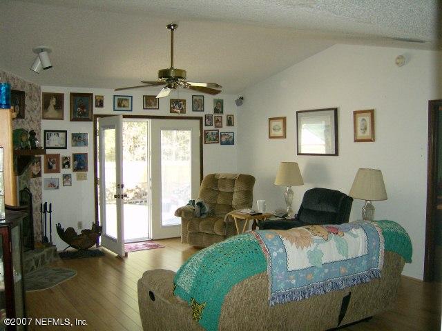 1567 Panther Ridge Court Jacksonville, FL 32225 - Photo 2 of 11 a living room with furniture and a chandelier
