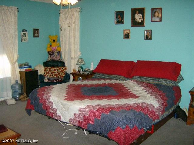1567 Panther Ridge Court Jacksonville, FL 32225 - Photo 5 of 11 a bedroom with a bed and cupboard