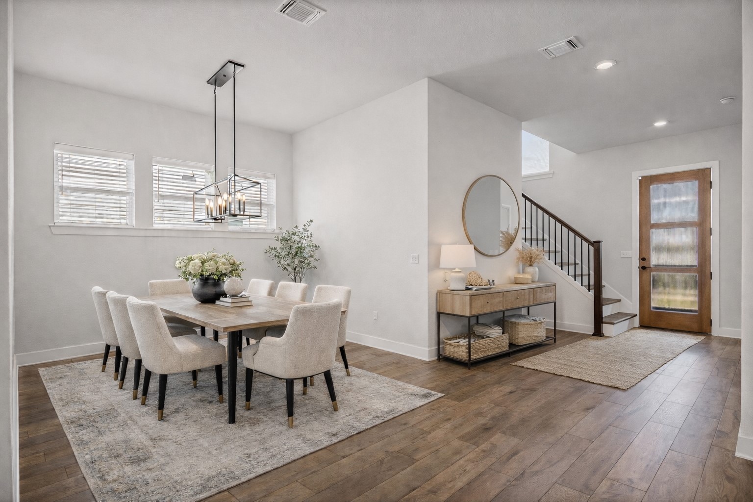 5806 Rangeland Road Austin, TX 78747 - Photo 4 of 34 Natural light illuminates rich wood flooring, leading to a sophisticated dining space and an inviting entry.
