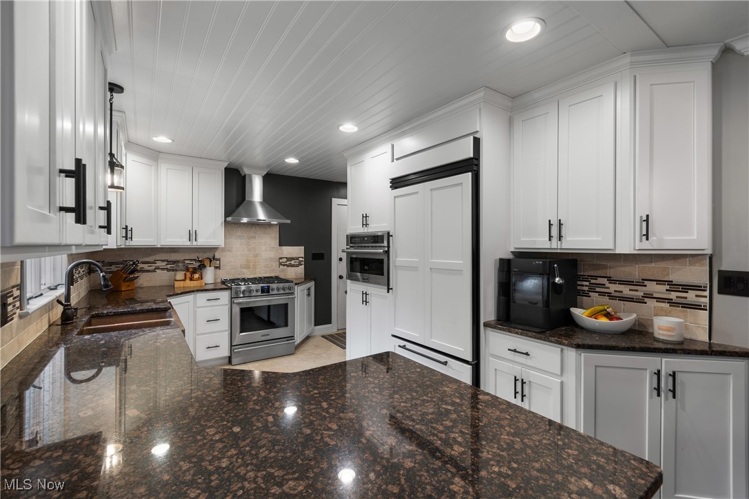 234 Reed Road Wooster, OH 44691 - Photo 11 of 36 Kitchen featuring dark stone countertops, white cabinetry, stainless steel appliances, decorative backsplash, and recessed lighting