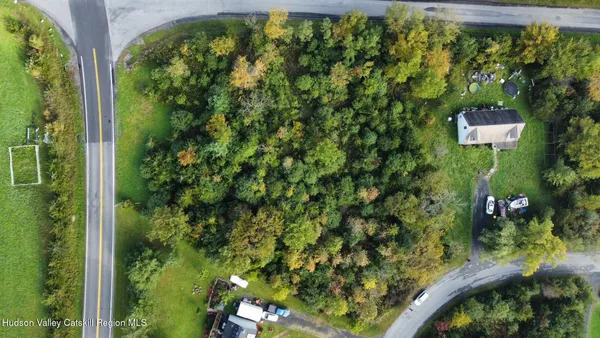 an aerial view of a residential houses with yard