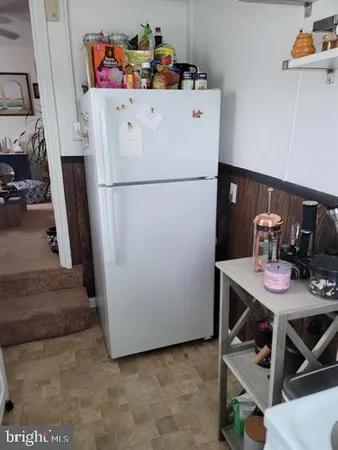 a white refrigerator freezer sitting in a kitchen