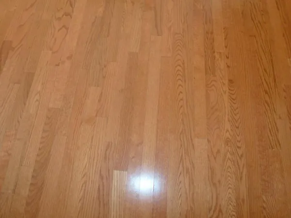 a view of a white wall with wooden floor