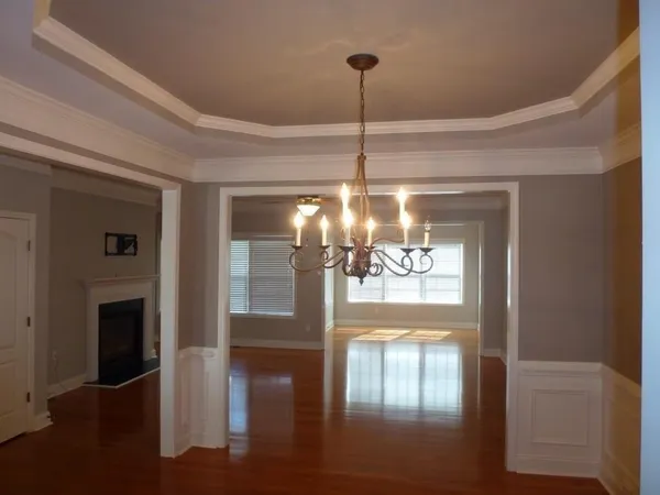 a view of a living room with a chandelier furniture and fireplace