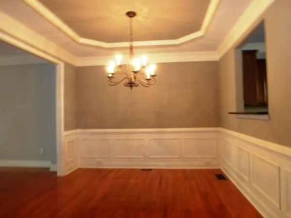a view of a room with a bathtub and chandelier