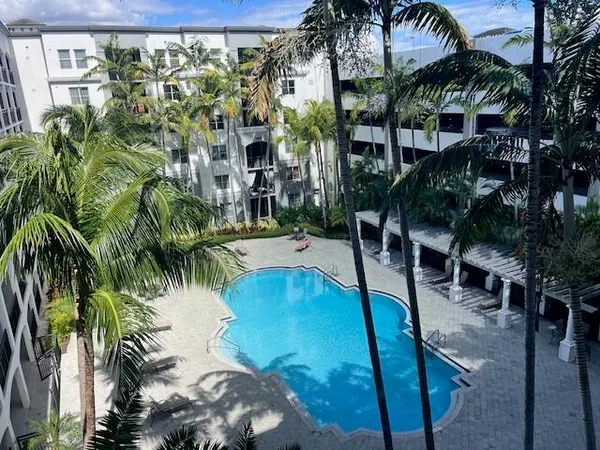 a view of swimming pool with a table and chairs