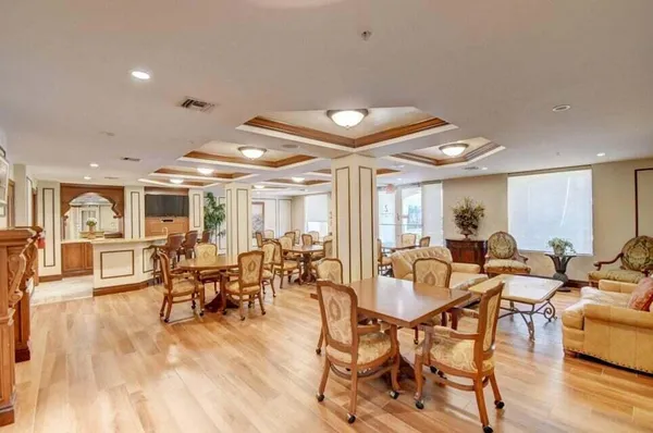 a living room with lots of furniture and a large window