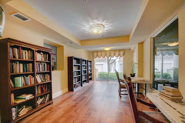 a view of a dining room with furniture and a book shelf