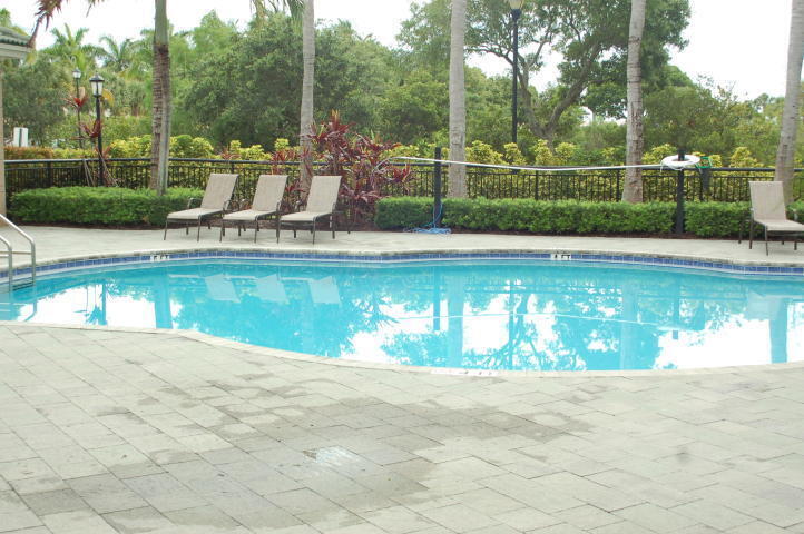 1690 Renaissance Commons Boulevard, Unit 1522 Boynton Beach, FL 33426 - Photo 5 of 31 a view of a swimming pool with a fountain in the background