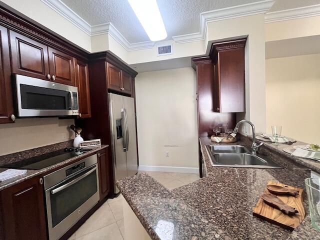 1690 Renaissance Commons Boulevard, Unit 1522 Boynton Beach, FL 33426 - Photo 7 of 31 a kitchen with granite countertop stainless steel appliances and wooden cabinets