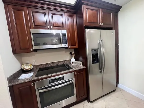 a kitchen with a refrigerator and stove