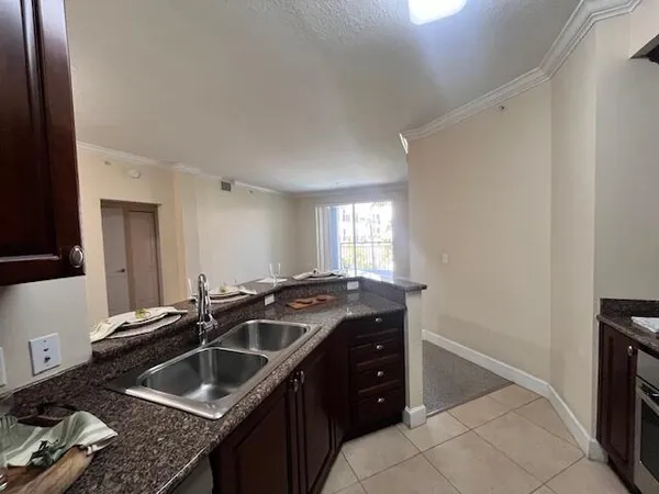 a kitchen that has a sink and a stove