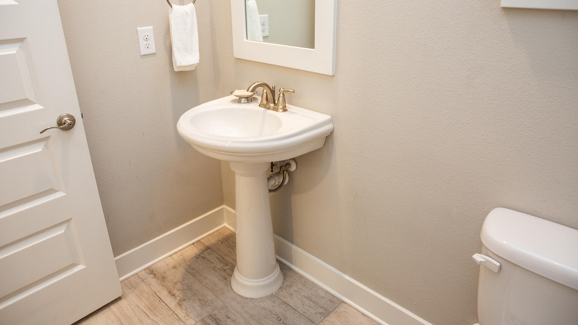 51 Dune Comet Lane, Unit A Panama City Beach, FL 32461 - Photo 11 of 63 a bathroom with a sink a toilet and a mirror