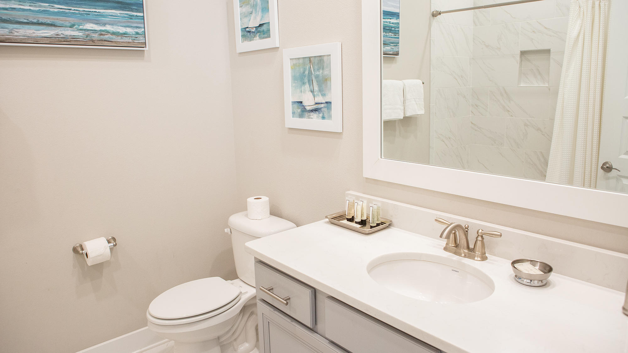 51 Dune Comet Lane, Unit A Panama City Beach, FL 32461 - Photo 19 of 63 a bathroom with a sink vanity mirror and toilet