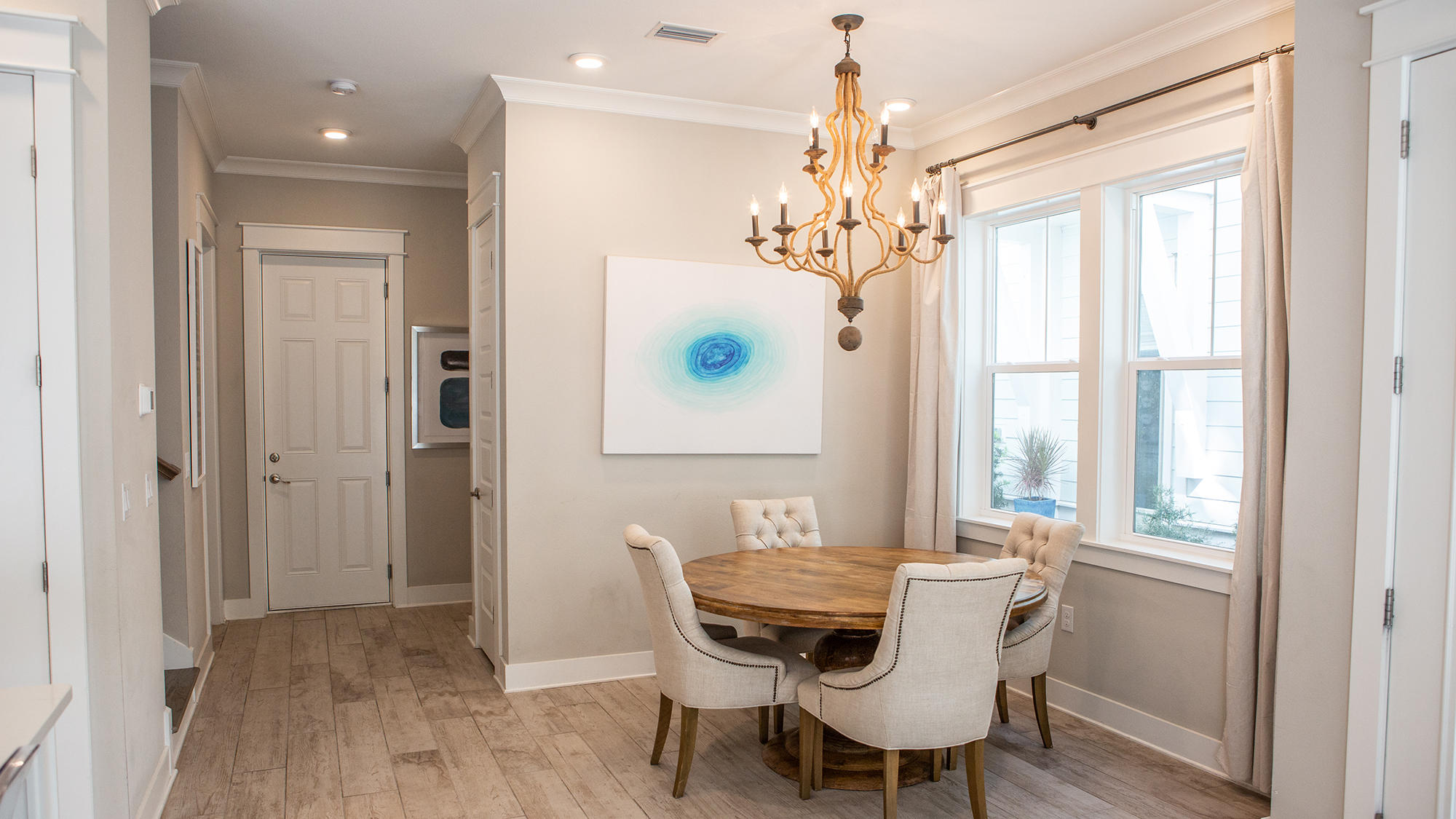 51 Dune Comet Lane, Unit A Panama City Beach, FL 32461 - Photo 4 of 63 a view of a dining room with furniture window and wooden floor