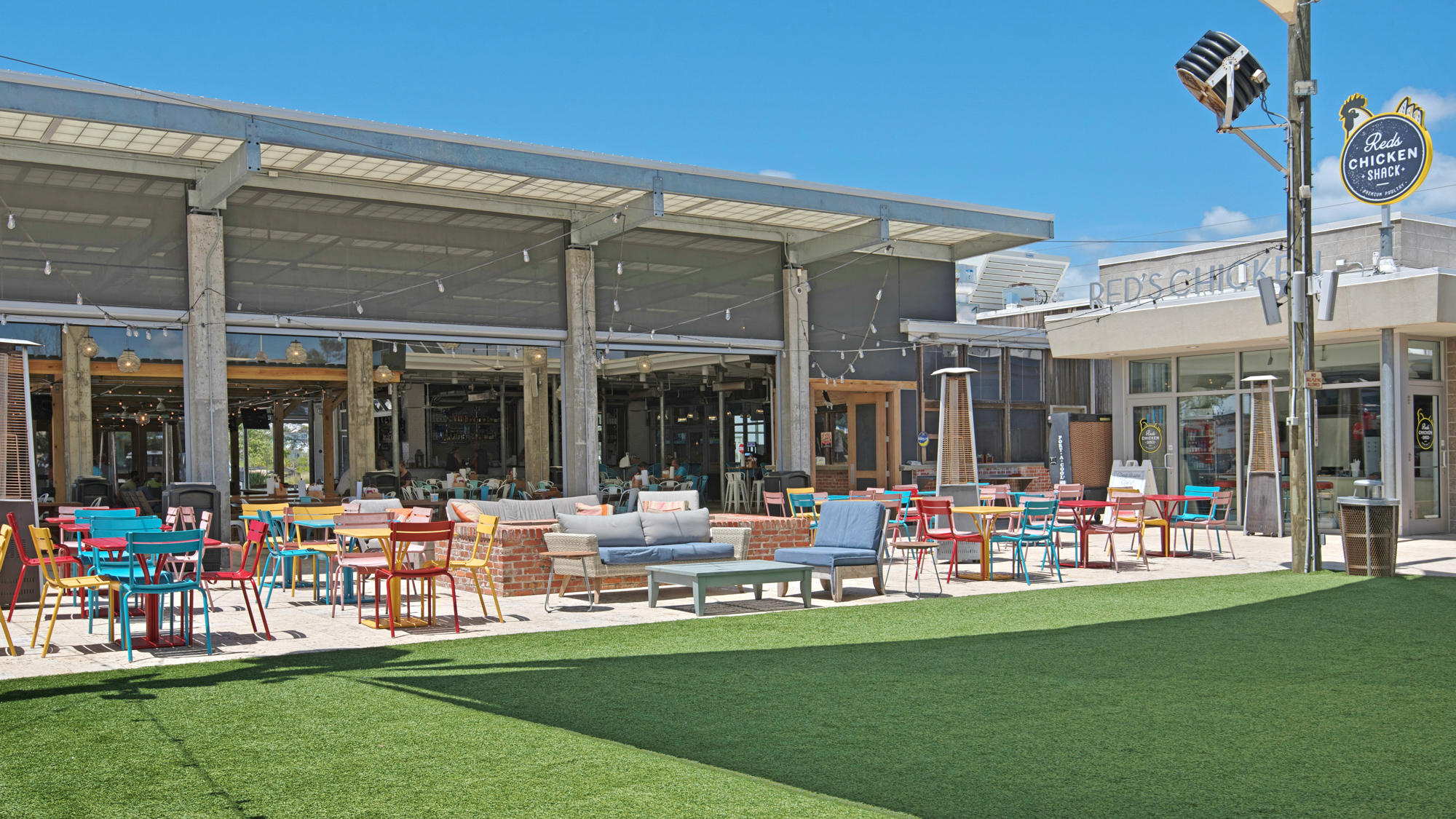 51 Dune Comet Lane, Unit A Panama City Beach, FL 32461 - Photo 35 of 63 a group of people sitting in front of a store