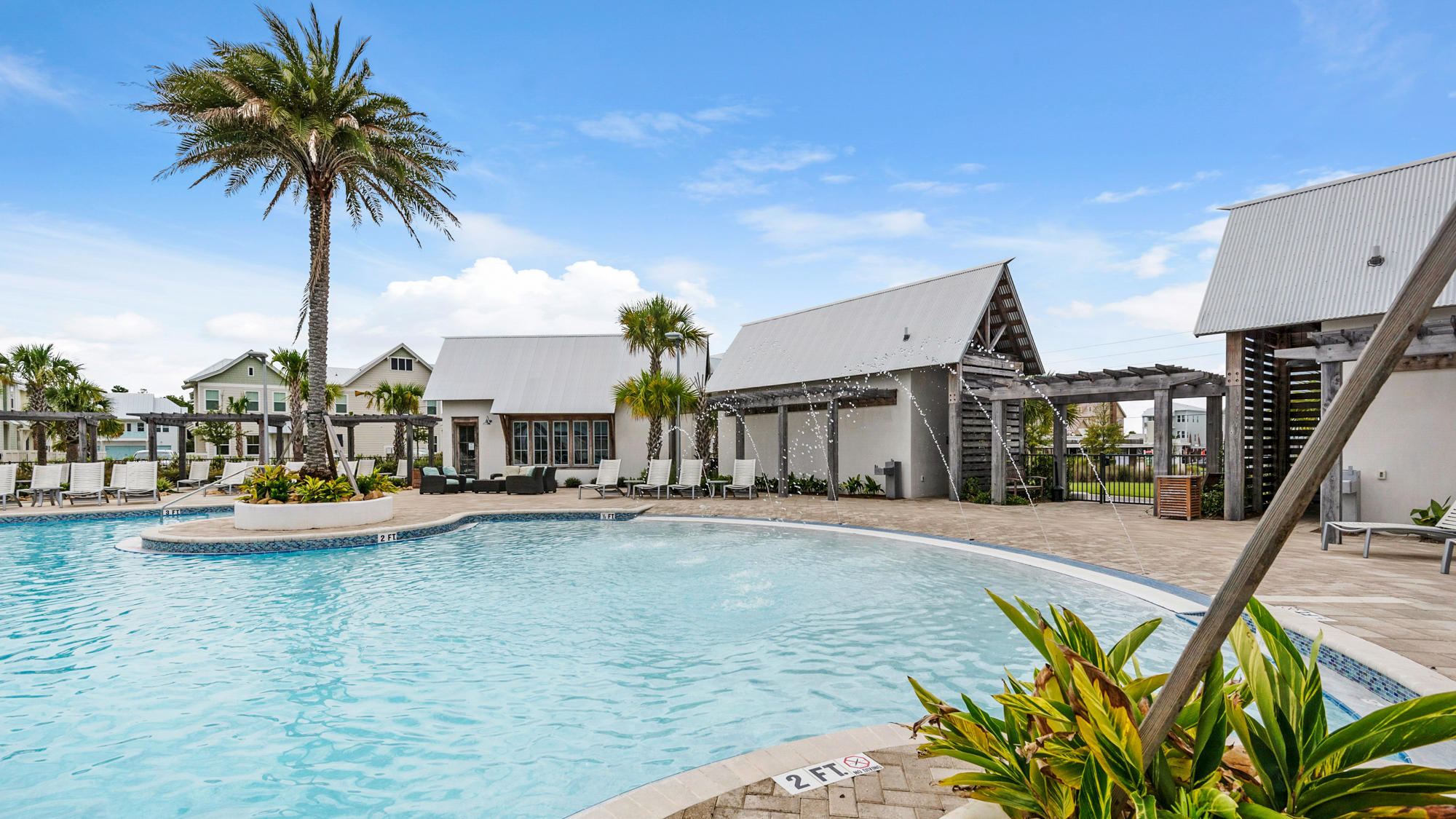 51 Dune Comet Lane, Unit A Panama City Beach, FL 32461 - Photo 36 of 63 a view of a swimming pool with a lawn chairs and palm tree