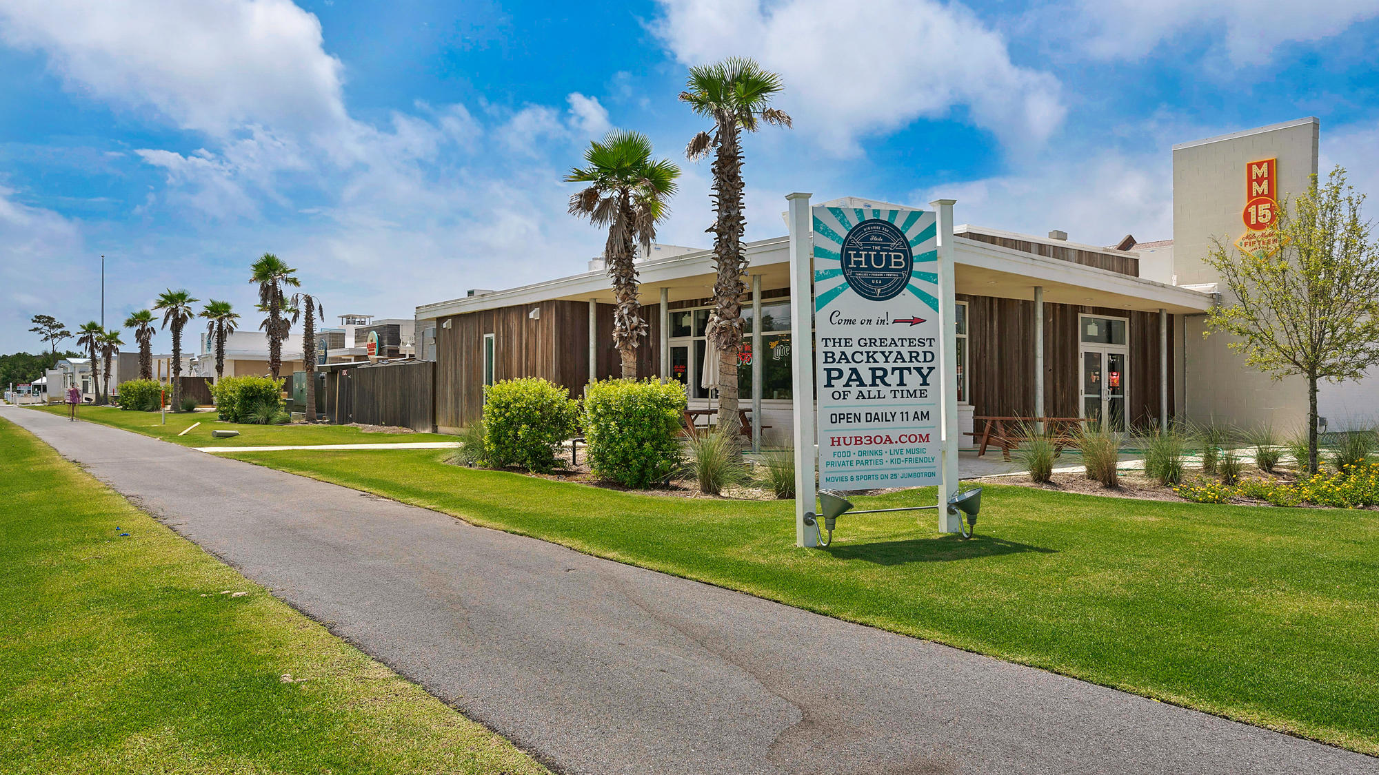 51 Dune Comet Lane, Unit A Panama City Beach, FL 32461 - Photo 45 of 63 a front view of a house with a yard and palm trees