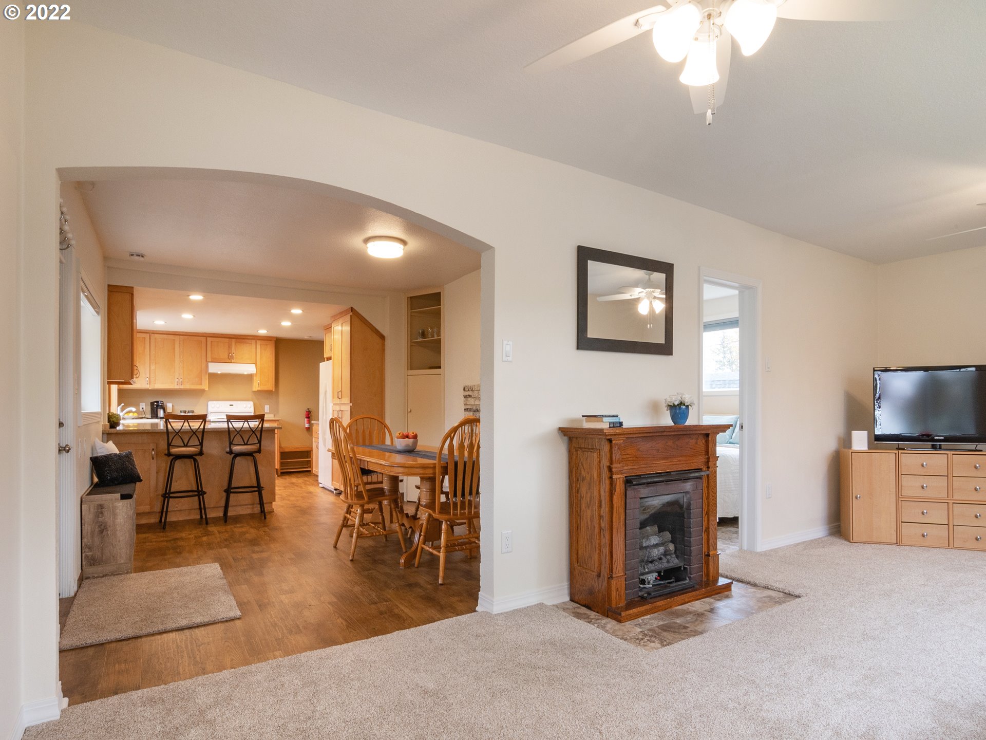 1340 E Street Springfield, OR 97477 - Photo 13 of 32 a living room with furniture a flat screen tv and a dining table