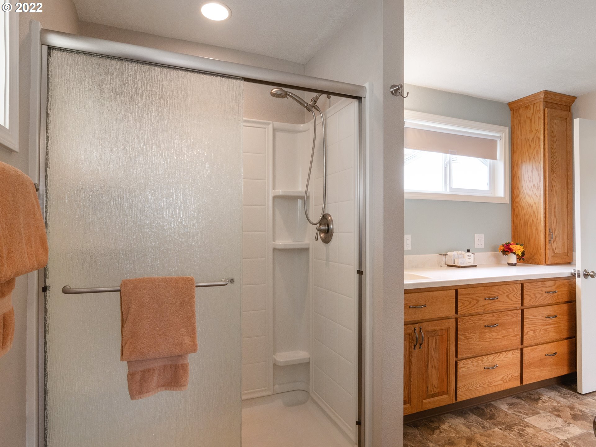 1340 E Street Springfield, OR 97477 - Photo 23 of 32 a bathroom with a shower sink and mirror