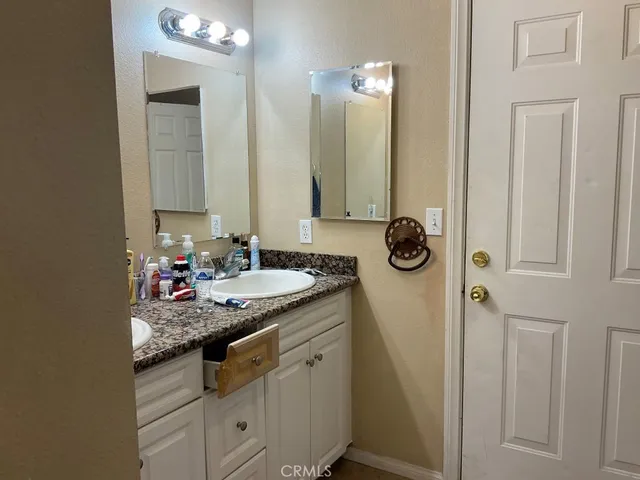 a bathroom with sinks granite countertop a sink and a mirror